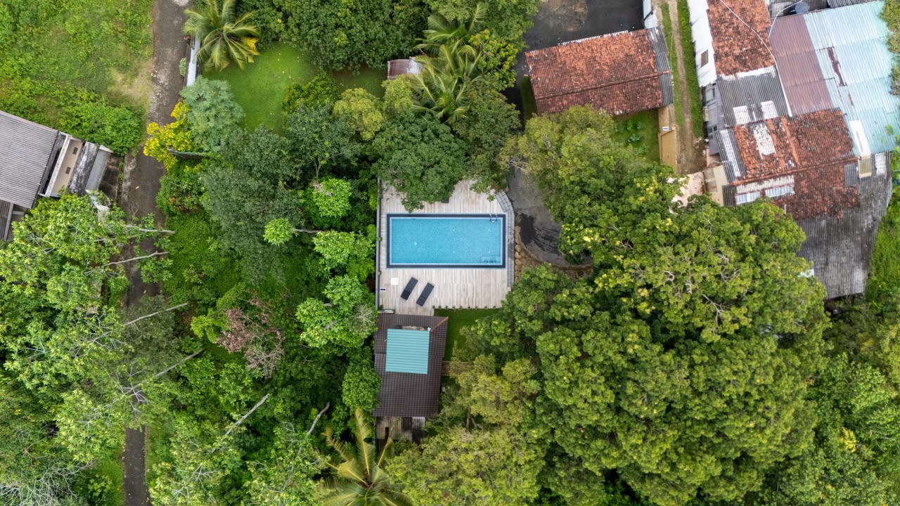 Aerial view of The Grand Luna Villa among trees